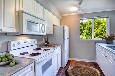 a kitchen with white appliances and white cabinets