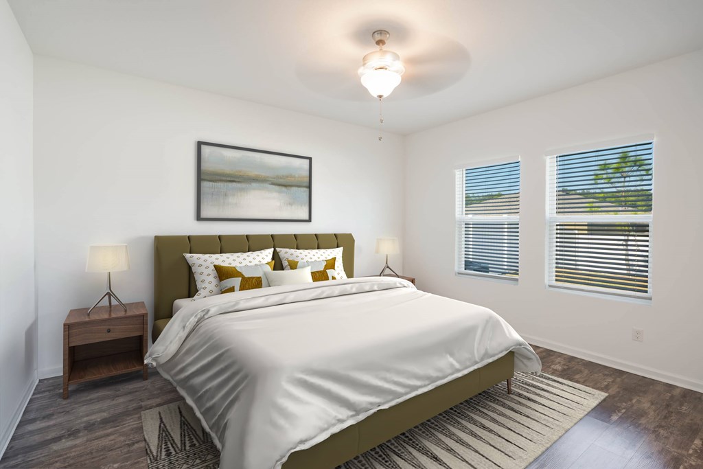 A bedroom with a large bed and a painting on the wall.