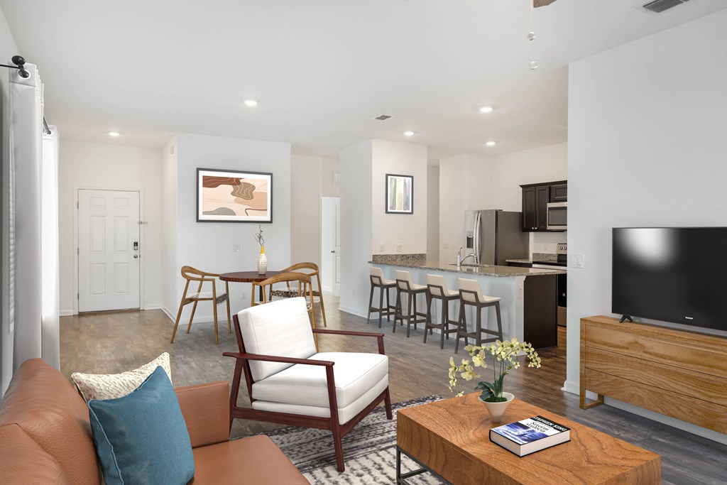 A living room with a brown couch, a wooden coffee table, and a television.