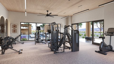 A spacious gym with a variety of equipment and a view of the outdoors.