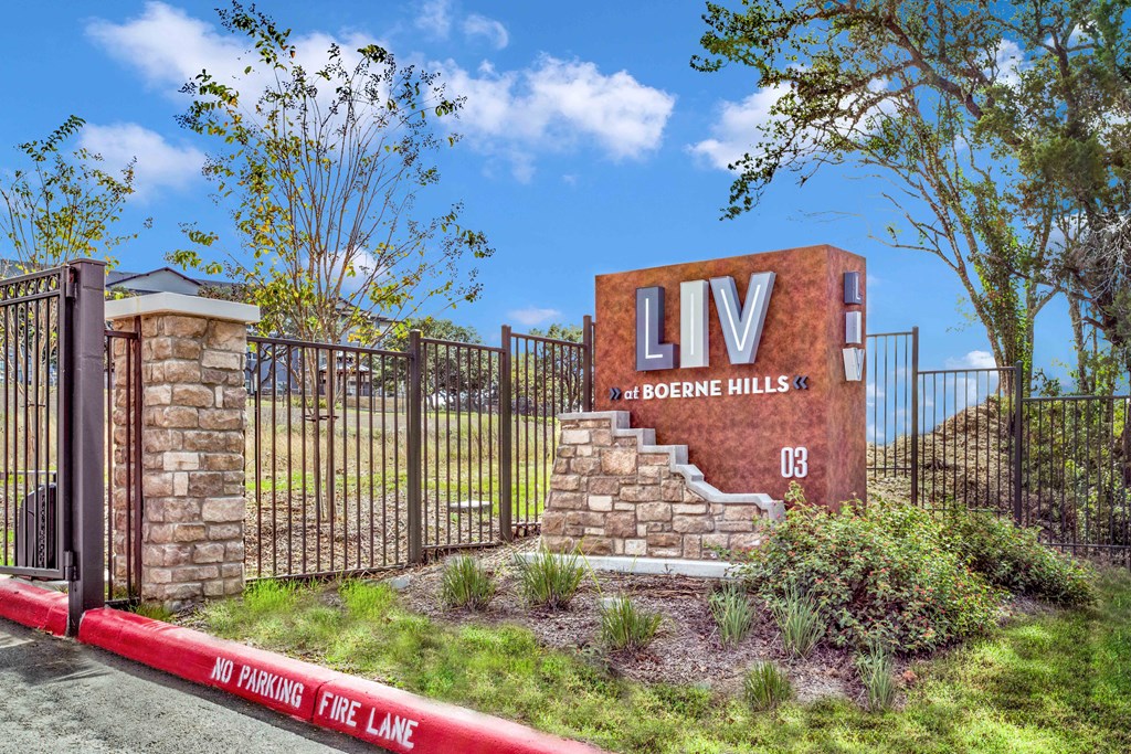 the sign at the entrance to liv above the hills in front of a gate