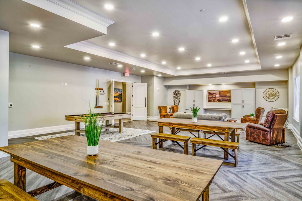 a living room with tables and chairs and a dining table at LIV at Boerne Hills an Active Senior Community 62+, Boerne, TX, 78006