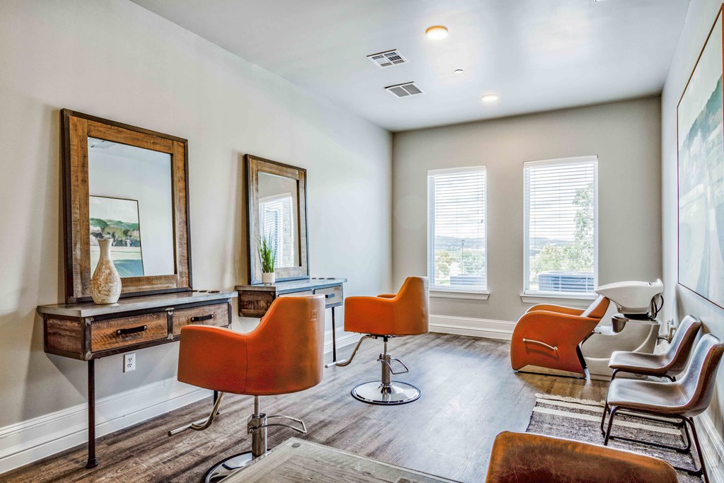 a living room with chairs and a table and a mirror at Boerne Hills an Active Senior Community 62+, Texas