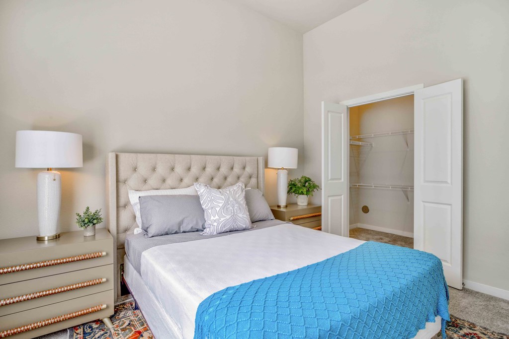 a bedroom with a large bed and a closet at LIV at Boerne Hills an Active Senior Community 62+, Boerne, TX