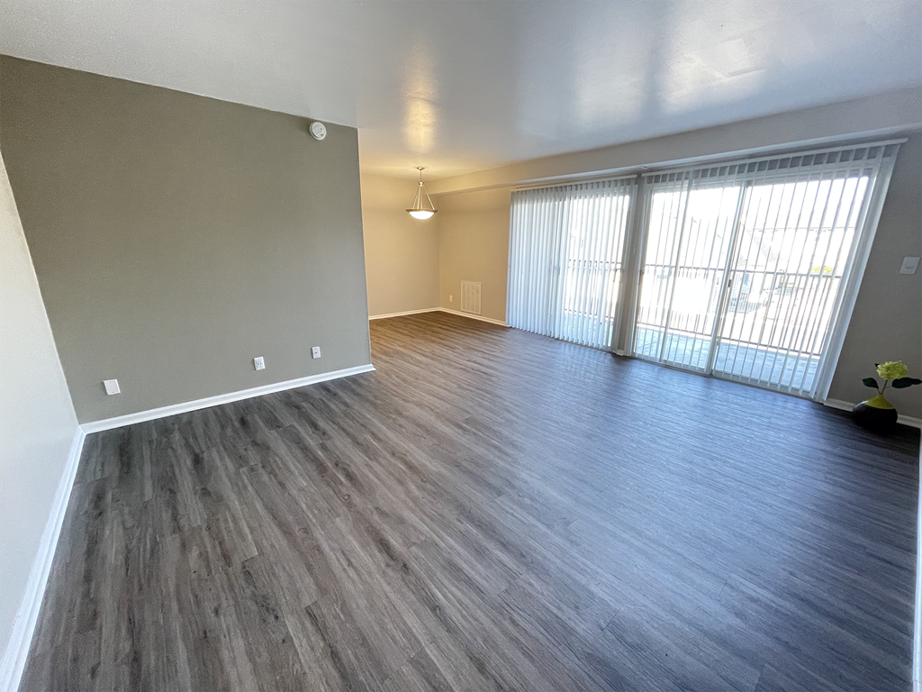 an empty living room with a sliding glass door