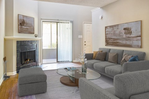 a living room with a couch and a table and a fireplace