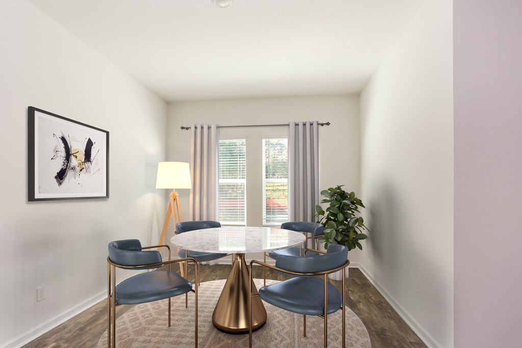 A modern dining room with a gold table and chairs.