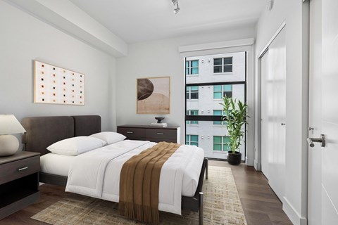 Spacious bedroom at MB Station apartments featuring large windows, modern finishes, and natural light near Brickell, Coral Gables, and Downtown Miami.