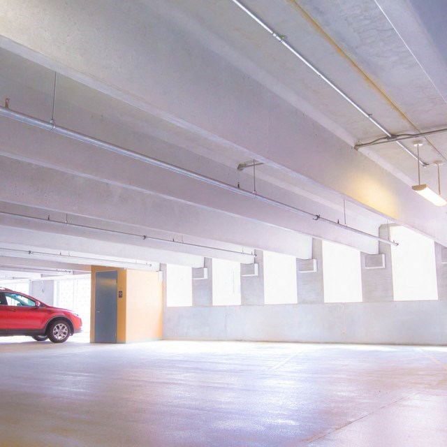a red car parked in a parking garage