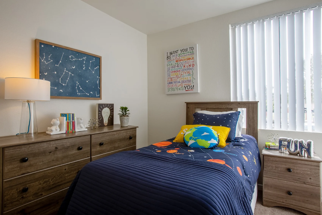 Bright bedroom with large window at Midtown on Seneca, a pet-friendly apartment community near East Central Tucson, Tucson, AZ.