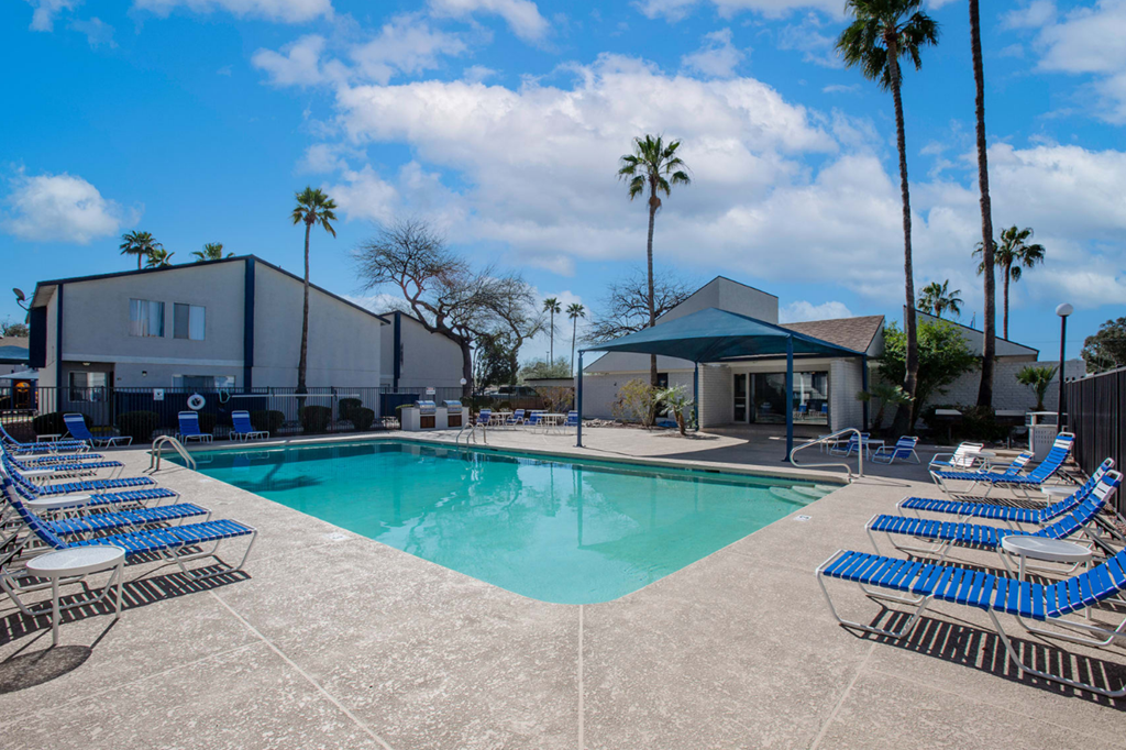 Swimming pool with outdoor seating at Midtown on Seneca, a pet-friendly apartment community near East Central Tucson, Tucson, AZ