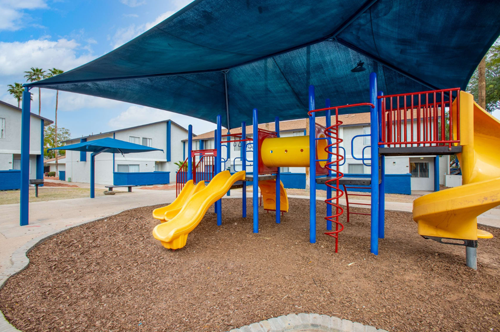 Family-friendly playground with modern equipment at Midtown on Seneca, a pet-friendly apartment community near East Central Tucson, Tucson, AZ.