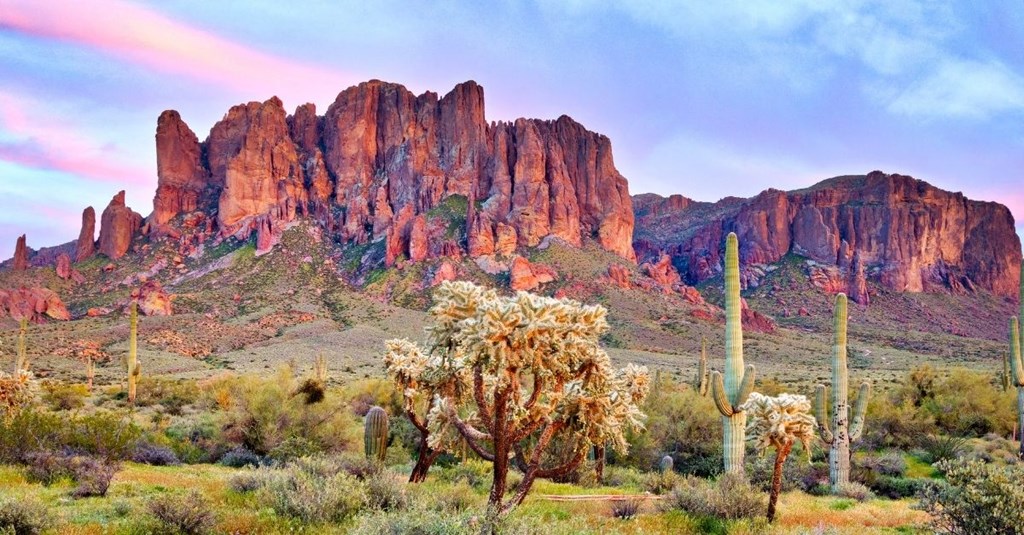 a view of the superstitions of monument valley at sunset