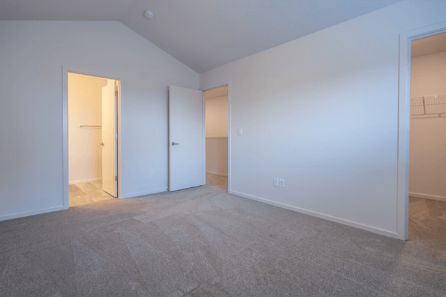 a bedroom with a carpeted floor and white walls