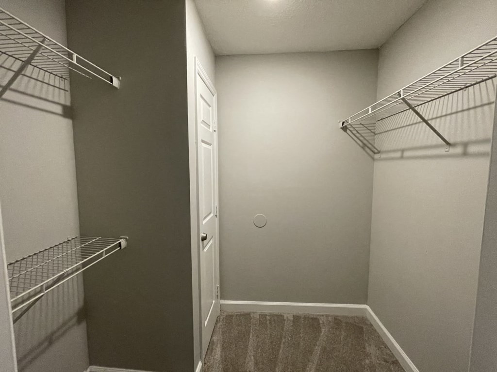 a walk in closet at the oxford at estonia apartments in san antonio,