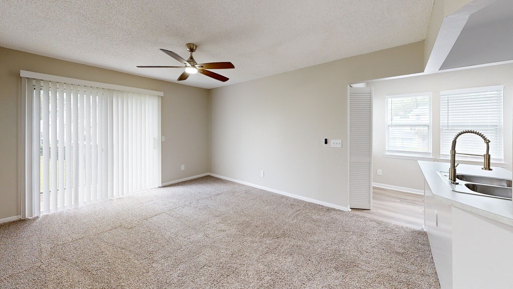 Oasis of Mandarin Apartments in Jacksonville, FL photo of  living room with patio door and ceiling fan