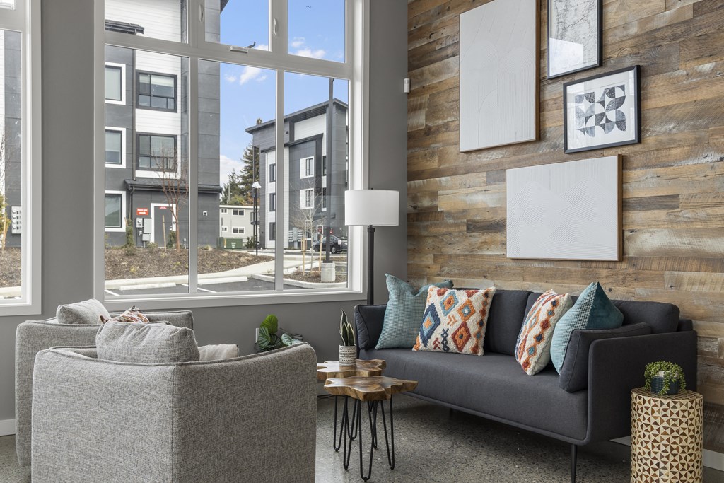 seating area with a couch and chairs in front of a large window,