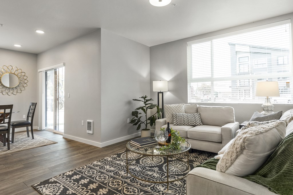 Apartments in Tacoma WA for rent - Pacific Ridge - living room with stylish décor, large window, and access to dining area,