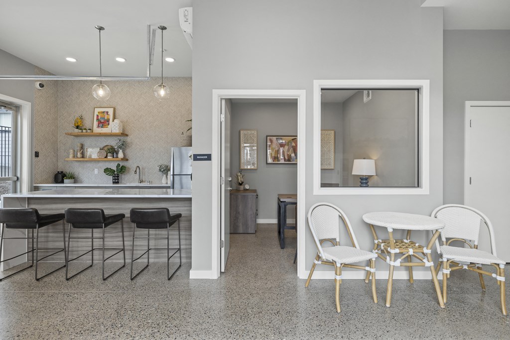 a rendering of the kitchen and dining area of a apartment with gray walls and a granite floor,