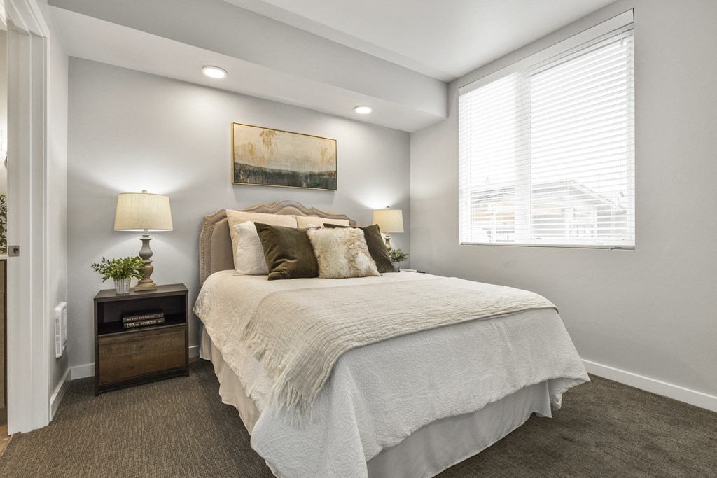 1 BR Apartments in South End Tacoma WA - Pacific Ridge - Bedroom with Bed, Window, Carpetted Floors, Wall Art, and Nightstands