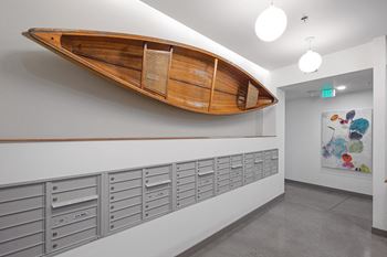 a wooden canoe hangs on the wall above a row of lockers