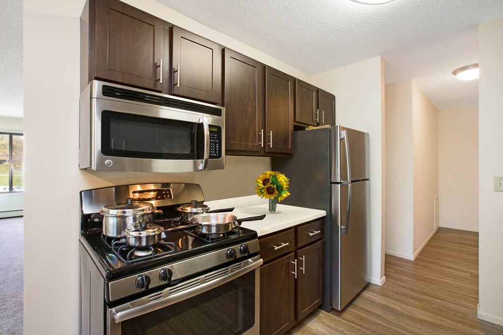 Stratford Wood Apartments and Townhomes in Minnetonka, MN Photo of kitchen with stainless steel appliances and espresso cabinets