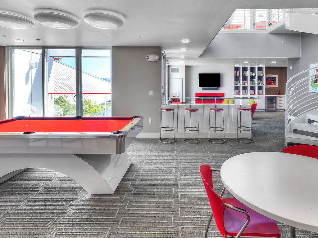 Sky lounge with pool table, wet bar, and gas fireplace at Astro Apartments, Washington