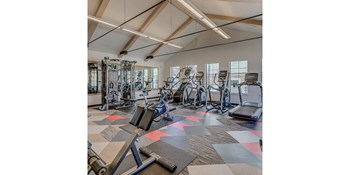Luxury Apartments in Tigard OR - Expansive Fitness Center Featuring Various Gym Equipment - Photo Gallery 14