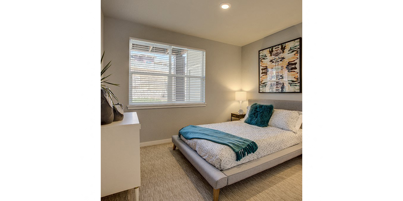 One Bedroom Apartments in Tigard OR - Sygnii - Furnished Bedroom with Carpet Flooring and a Window with Blinds