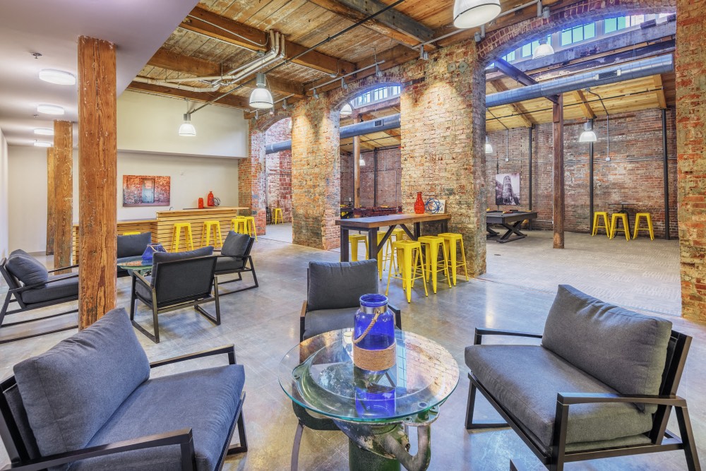 a living room with furniture and a glass table