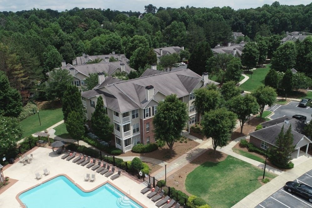 an aerial view of an apartment complex with a swimming pool
