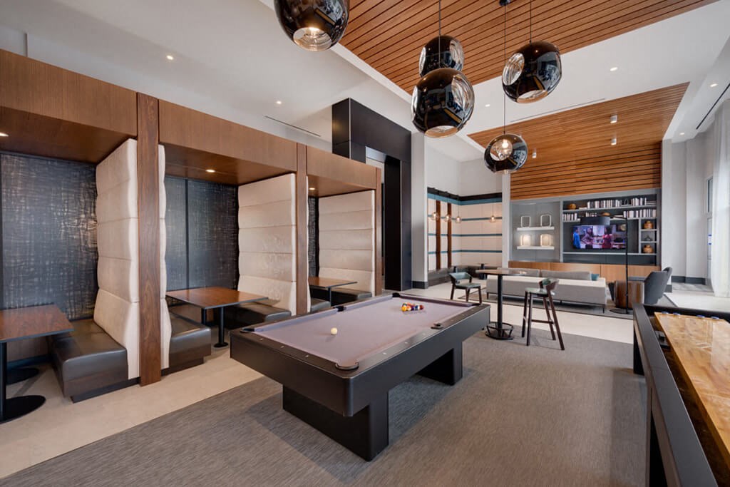 a game room with a pool table and a bar
