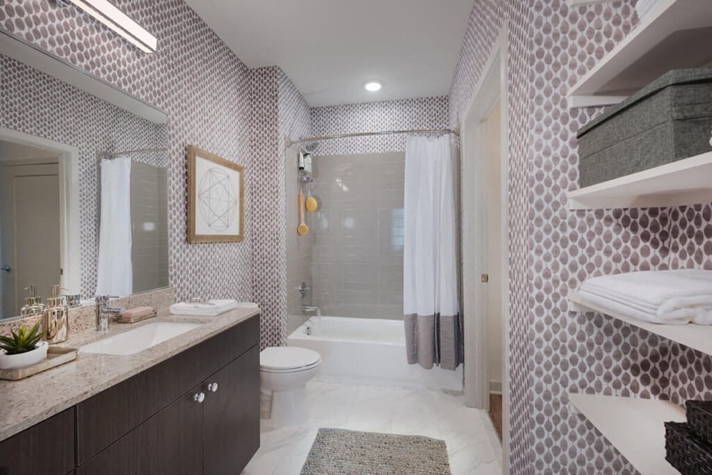 a bathroom with a shower and a sink and a toilet