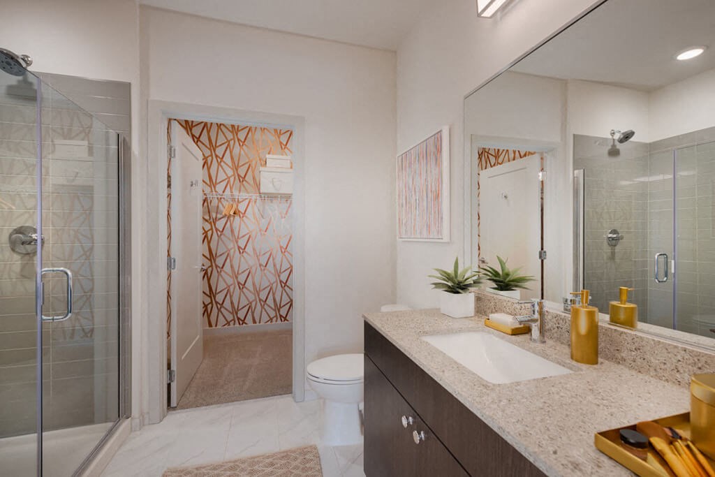 a bathroom with a shower and a sink and a mirror