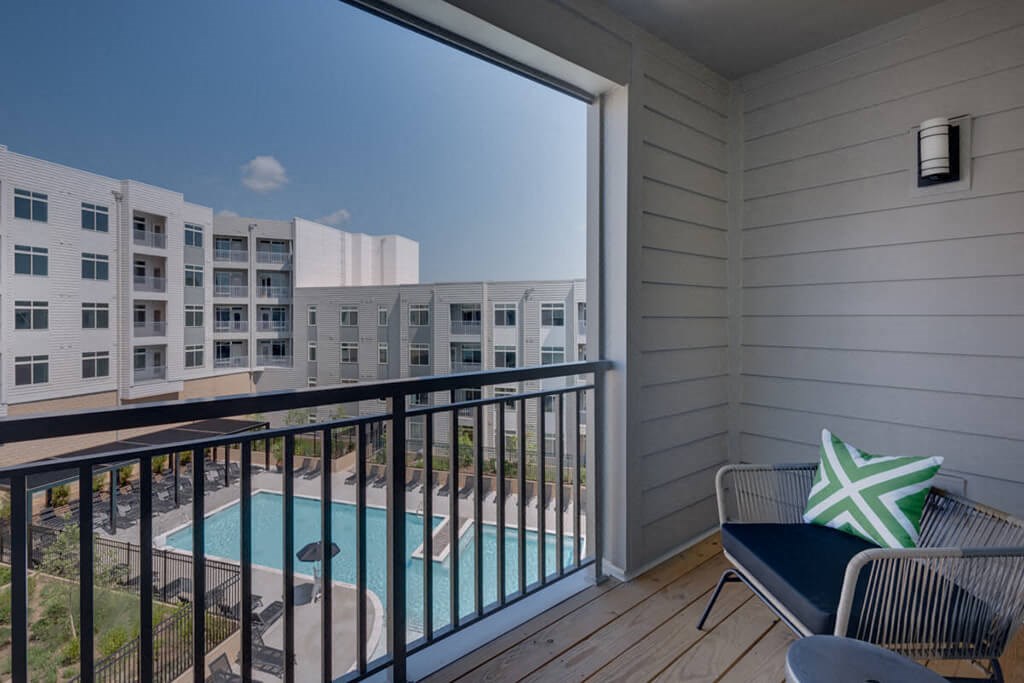 a balcony with a pool and a view of a building