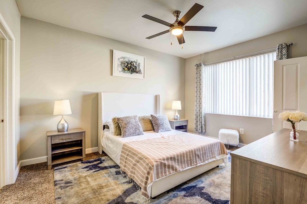 Henderson, NV Apartments For Rent - Avalon At Seven Hills - Spacious Bedroom With Plush Carpet Flooring, Ceiling Fan, And Window