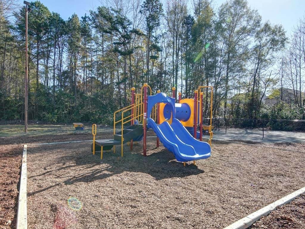 a playground with a blue and yellow slide