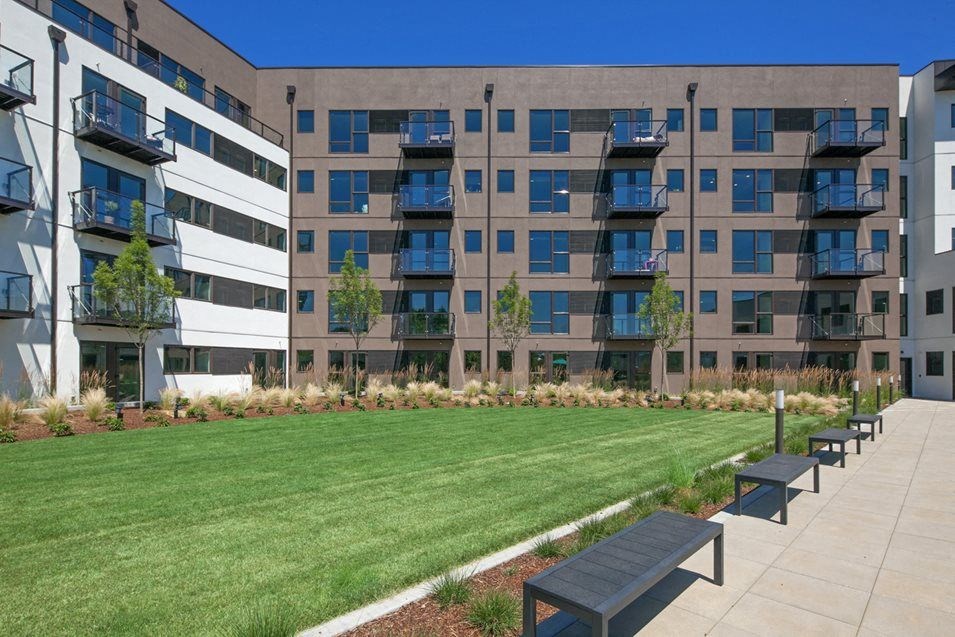 Apartments in South Portland OR - Oxbow49 - Spacious Grass Courtyard Surrounded by Benches