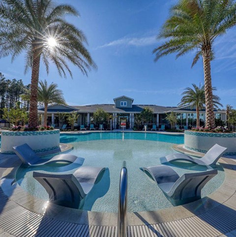 Resort-style swimming pool with sundeck at The Ridley Apartments near St. Johns Town Center and Jacksonville Beaches.