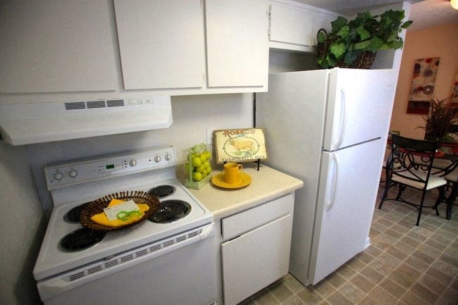 College Park, GA Apartments - Beacon Ridge - Kitchen with White Cabinets, White Appliances, and Tile Flooring