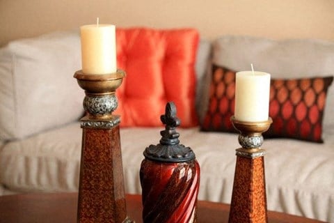 a living room with two candles on a table