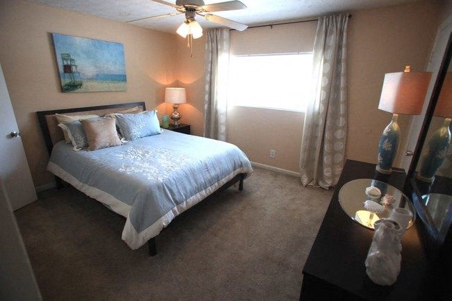 3-Bedroom Townhomes in College Park, GA - Beacon Ridge - Furnished Bedroom with Plush Carpet Flooring, a Window, a Ceiling Fan, and Stylish Decor