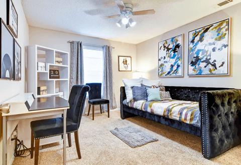 Spacious bedroom with a large window allowing abundant natural light, neutral walls, and plush carpeting at Wyndcliff Galleria.