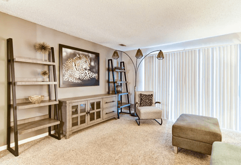 Spacious living room at Wyndcliff Galleria featuring an open layout, neutral paint, and plush carpeting.