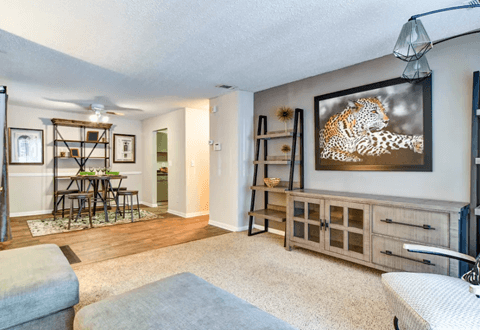 Living room and dining space in an open layout with soft carpeting at Wyndcliff Galleria.