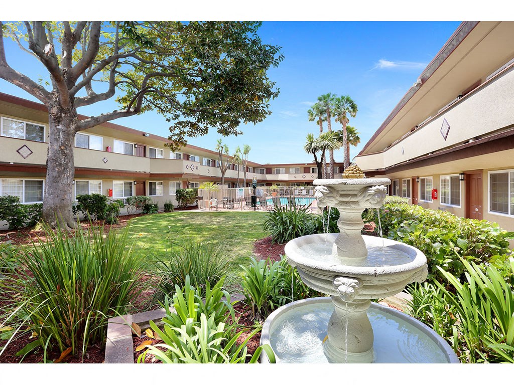 Apartments in Hayward CA - Paseo Gardens - Lush Courtyard with Water Fountain Next to the Pool in the Center of the Apartment Building