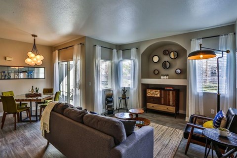 A living room with a grey couch and a wooden coffee table.
