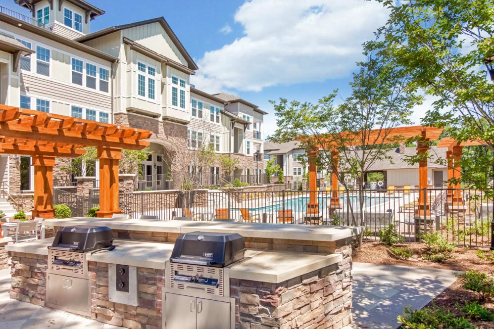 Outdoor kitchen with grilling station and pergolas