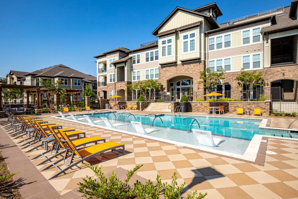Exterior apartment building with pool and pool furniture