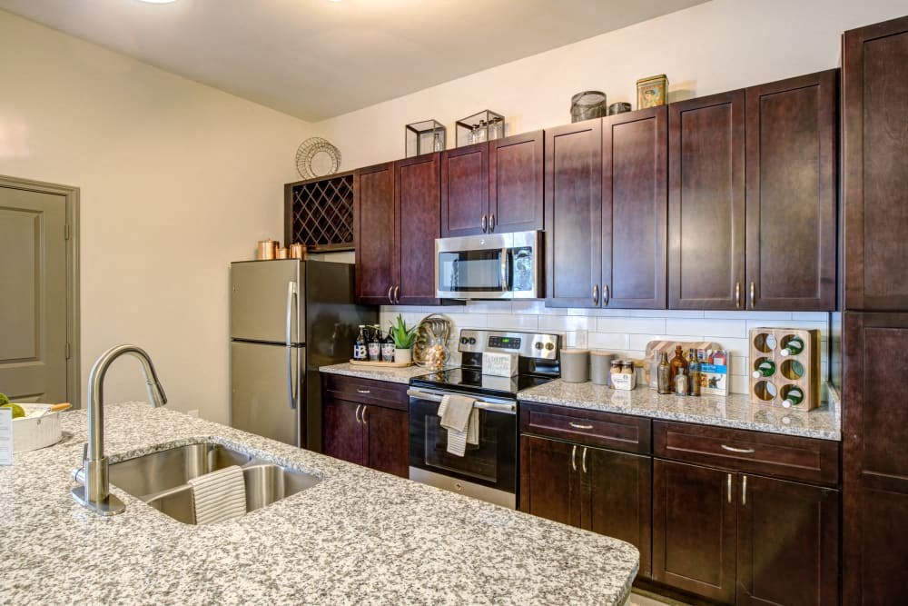 Kitchen with stainless steel appliances and dark cabinetry